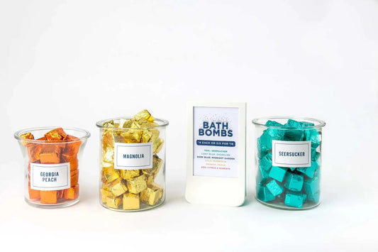 BathTime Rocks in glass jars, featuring Georgia Peach, Magnolia, and Seersucker scents.