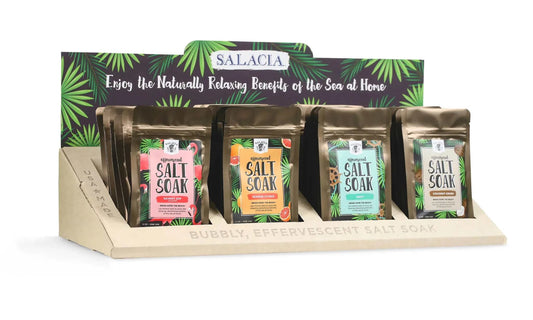 Effervescent Salt Soaks display with coconut and shea blend, featuring four fragrances: Seaside Citrus, Lemon Lavender, Drift, and Coconut Crush.