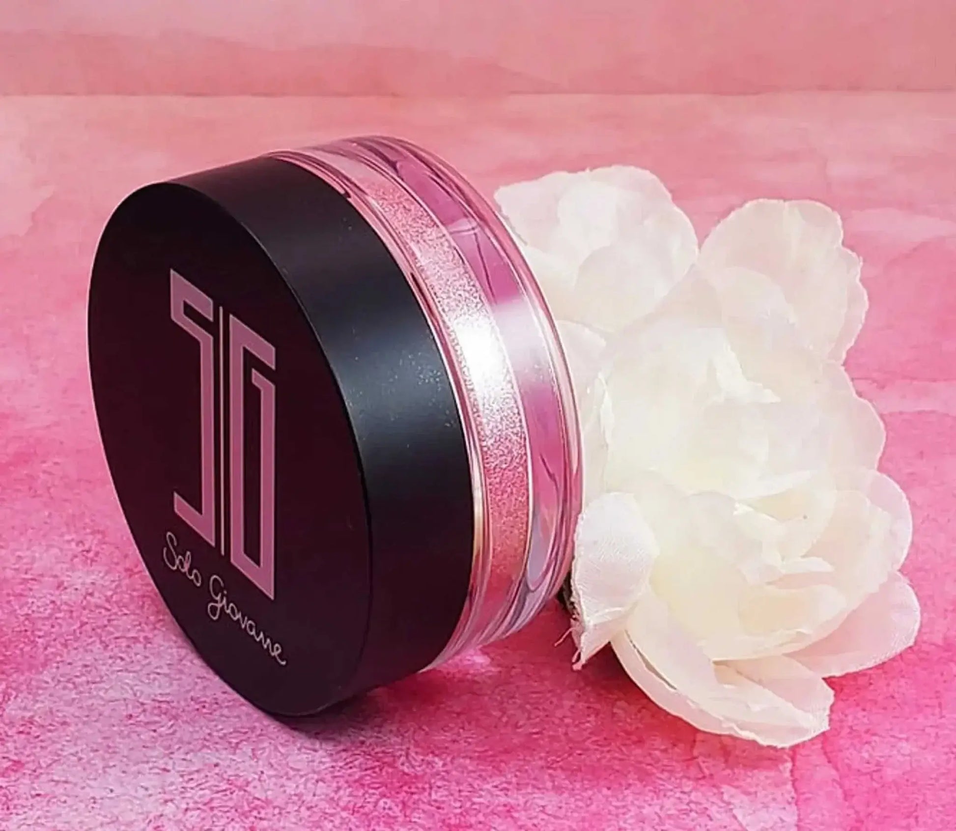 High pigment shimmering eyeshadow and highlighting powder in a sleek jar with floral decor.