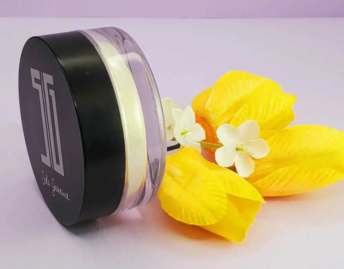 High pigment shimmering powder container with yellow and white flowers.