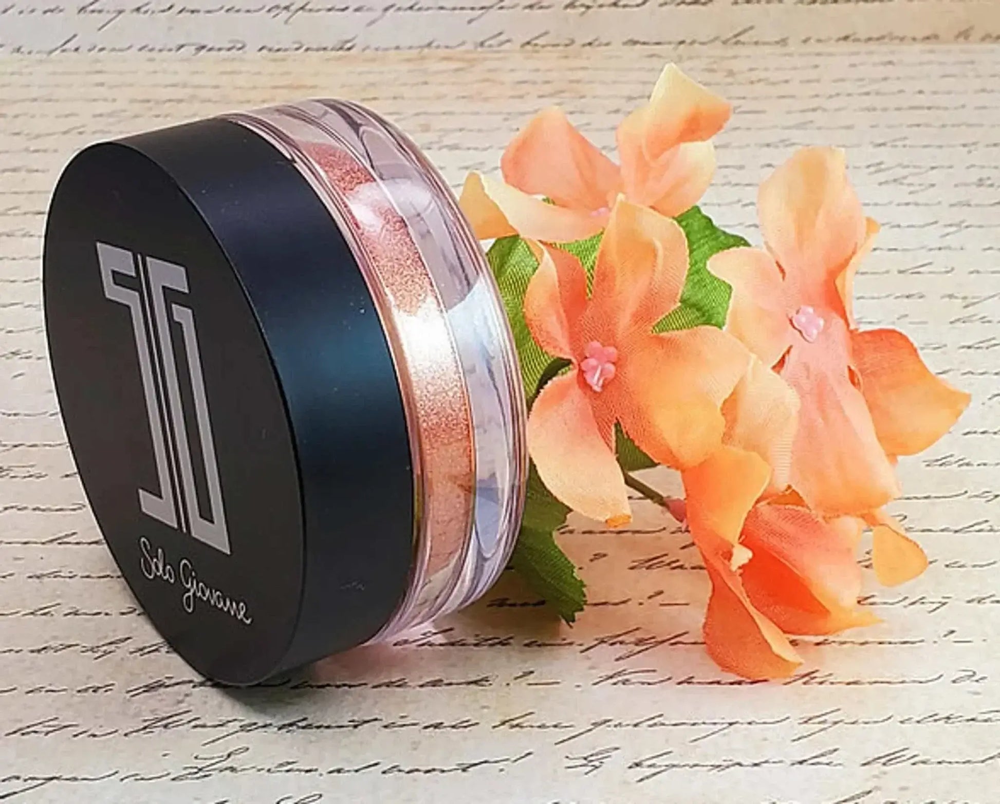 High pigment shimmering eyeshadow and highlighting powder with floral decor.