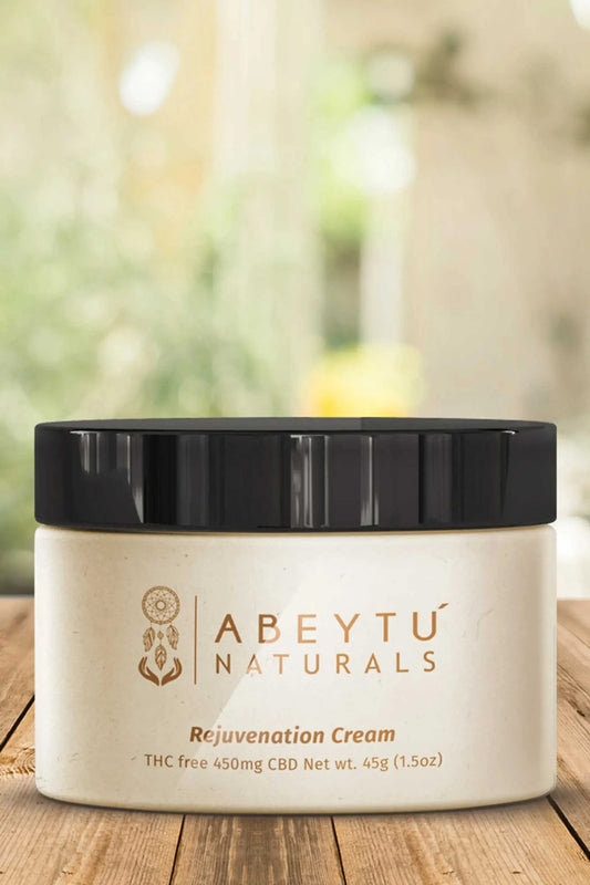 Rejuvenation Cream jar on a wooden table with nature backdrop.