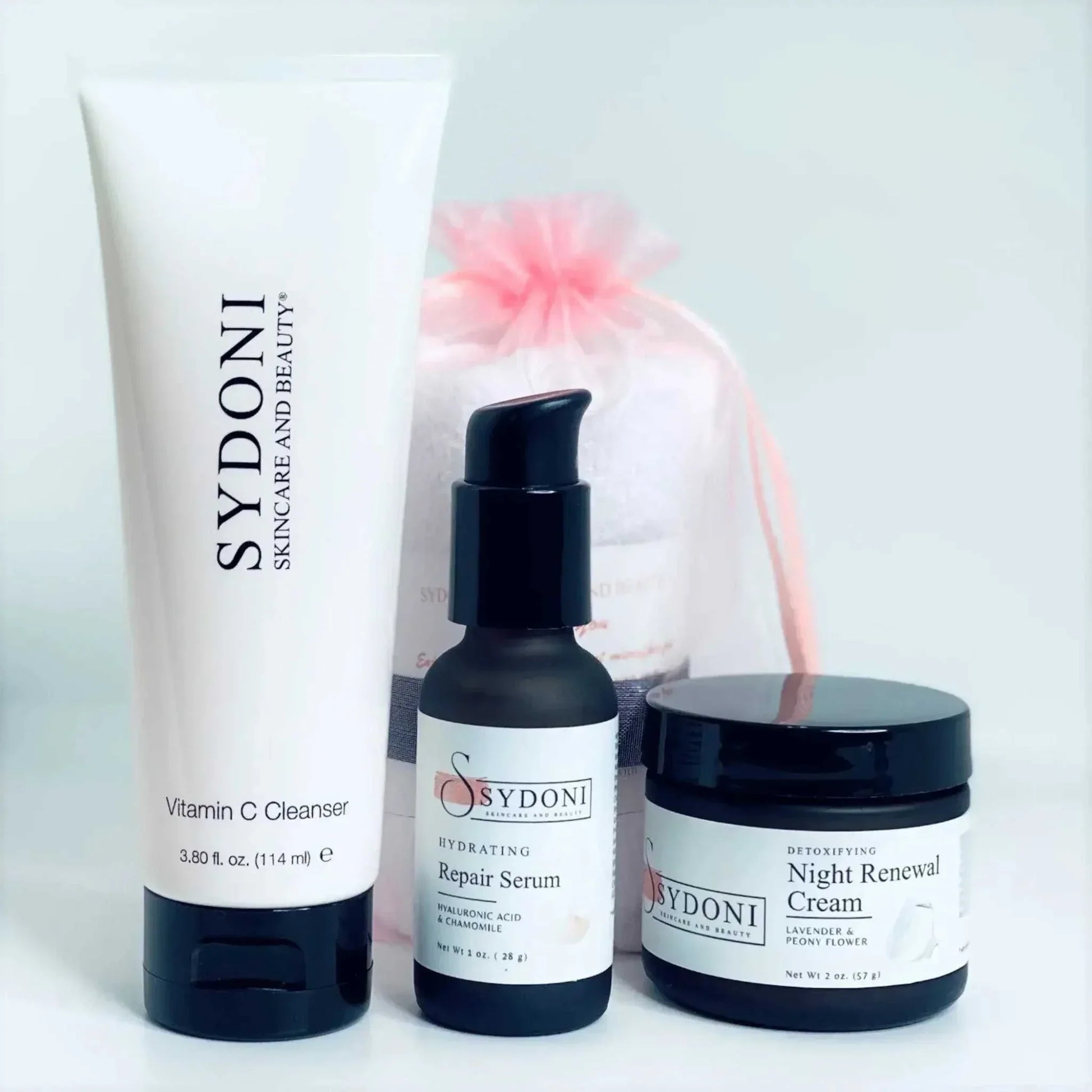 Brightening Detox Skincare Bundle featuring Vitamin C Cleanser, Hydrating Repair Serum, and Night Renewal Cream.