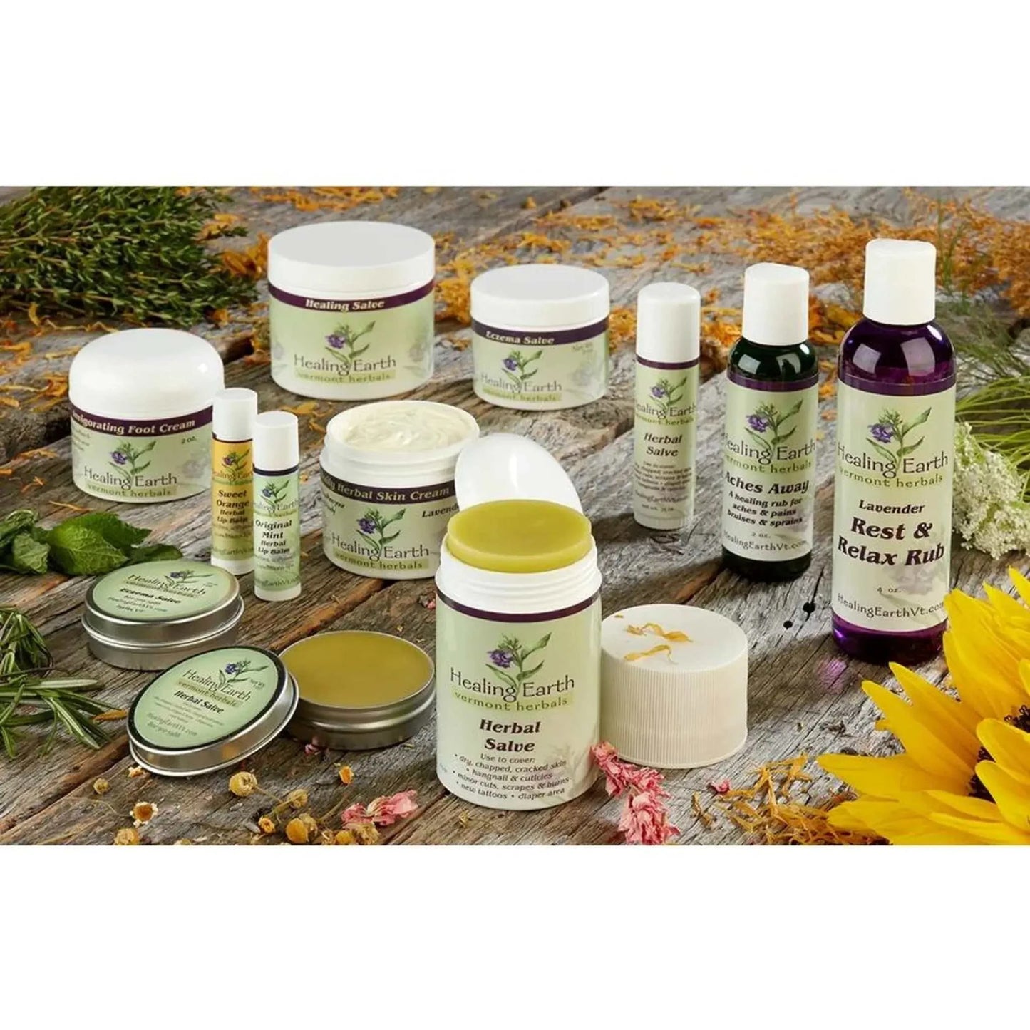 Handcrafted wooden display showcasing Healing Earth salves and creams collection, including Herbal Healing Salves and Rest & Relax Rub.