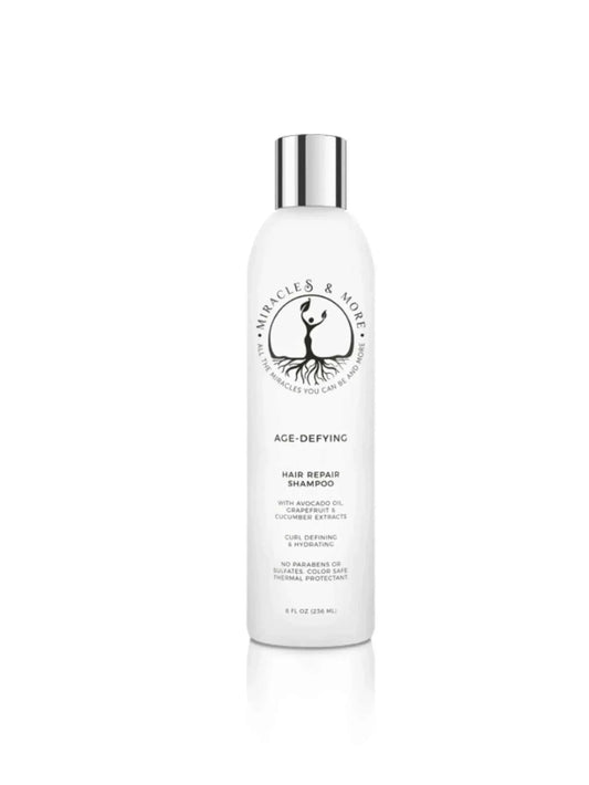 AGE-DEFYING HAIR REPAIR SHAMPOO bottle with cucumber and marigold extracts for vibrant, frizz-free curls.